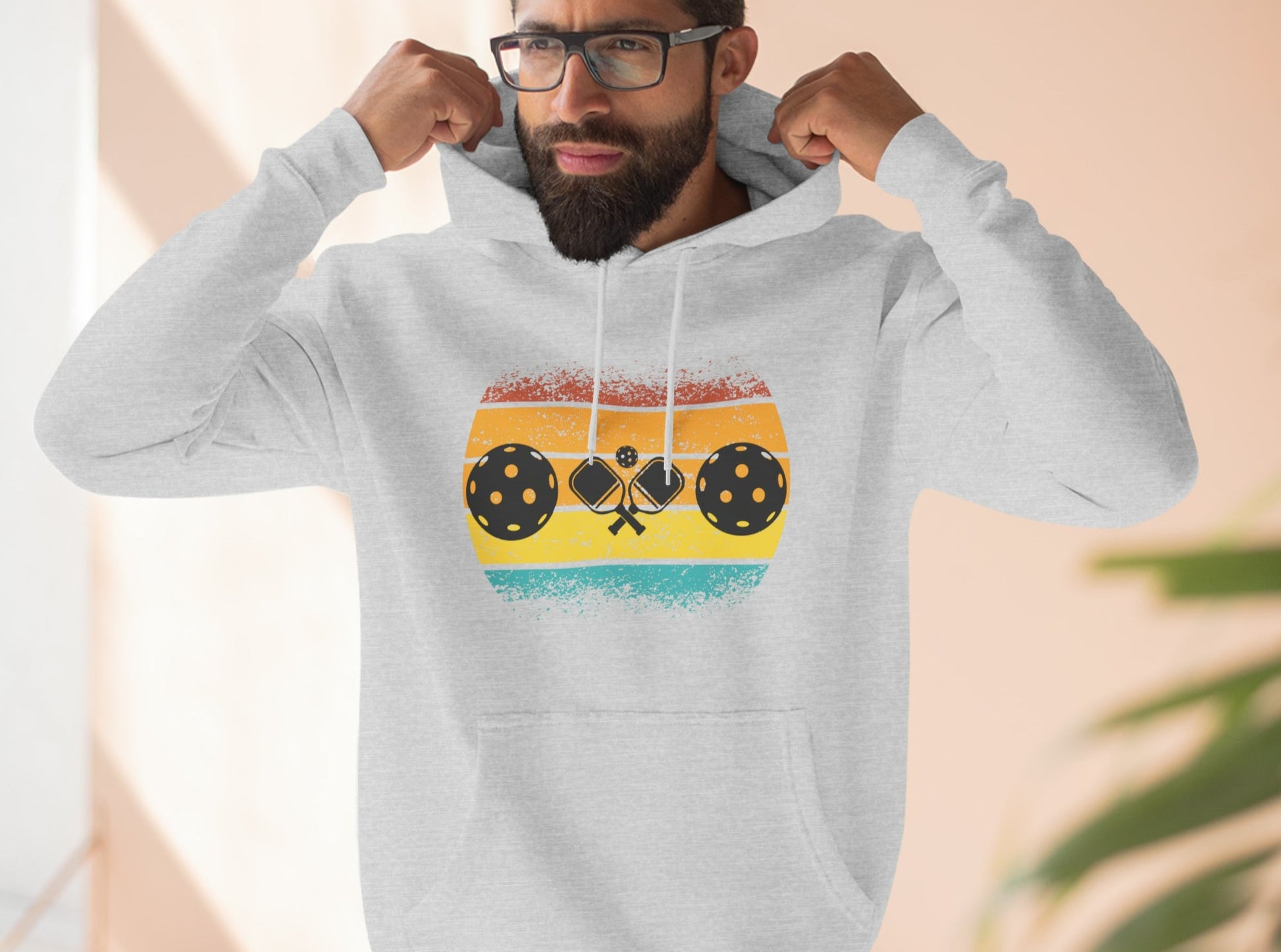 Another one of our gorgeous designs, the Unisex Tropical Pickleball Sunset Premium Pullover Hoodie